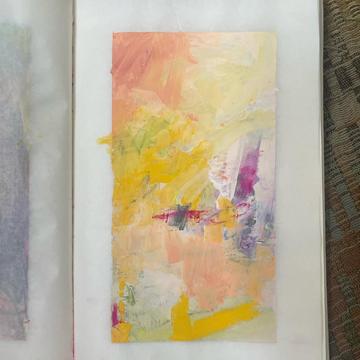 Open book with abstract art on a textured surface